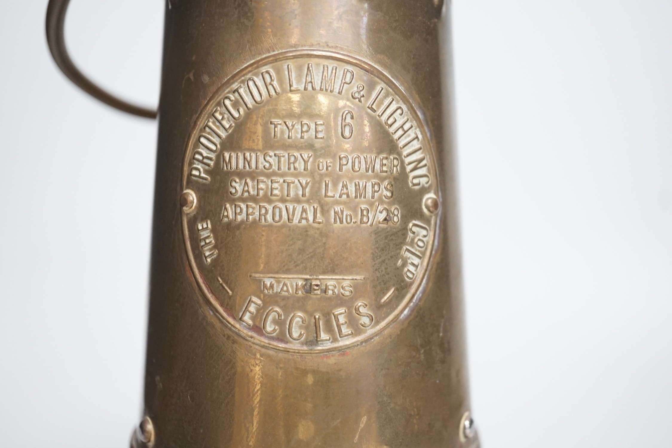 An Eccles miner’s lamp, 25cm high, together with a German harmonica